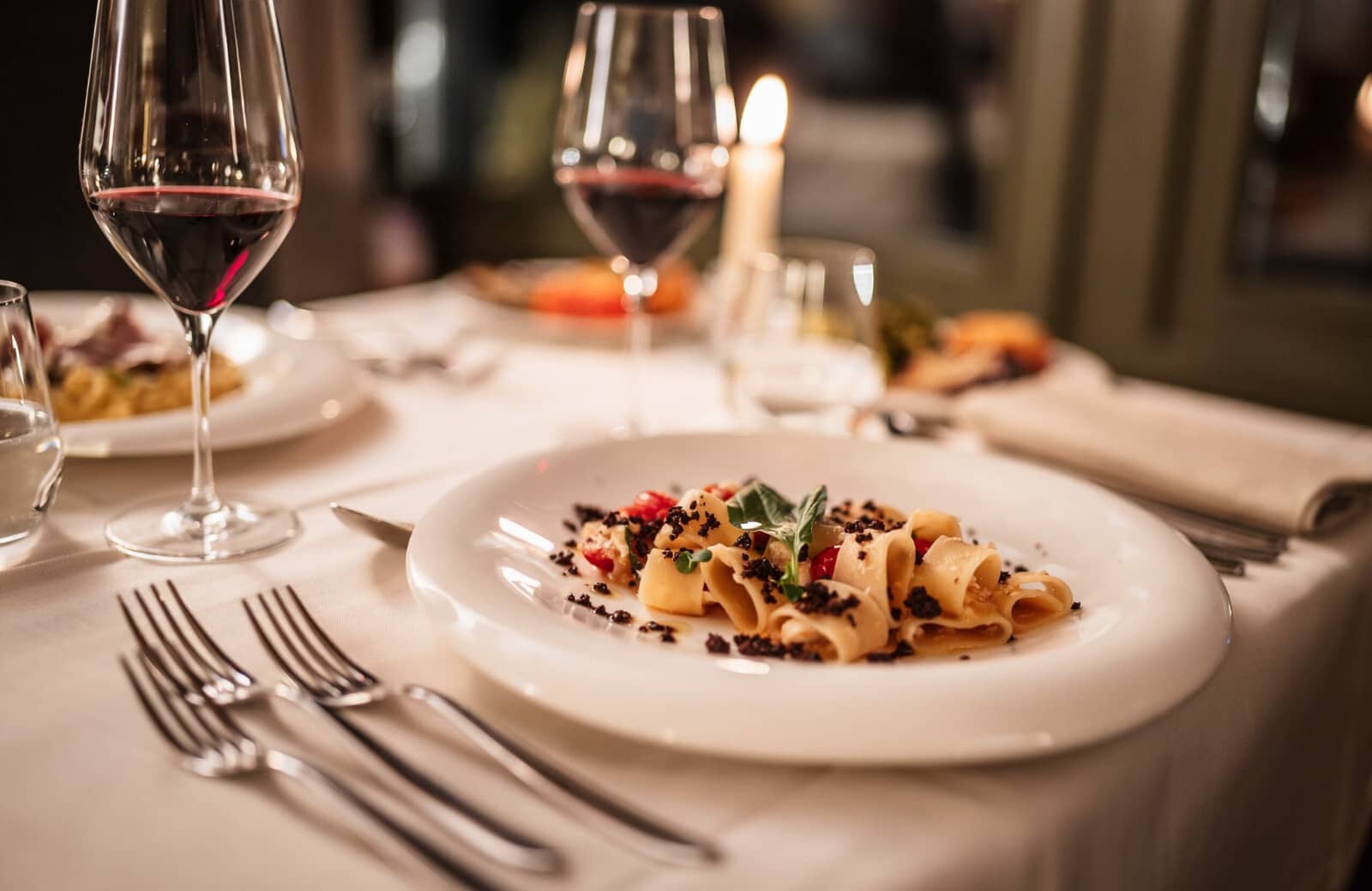 Dining area with fine china and formal place settings for four