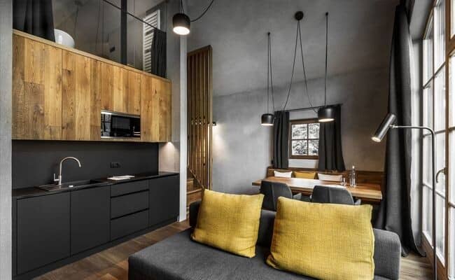 Open-plan kitchenette and living area with sleeping loft access