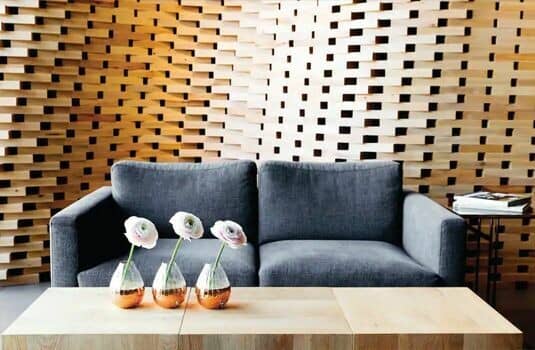 Living area with two-seat sofa and parametric wood feature wall