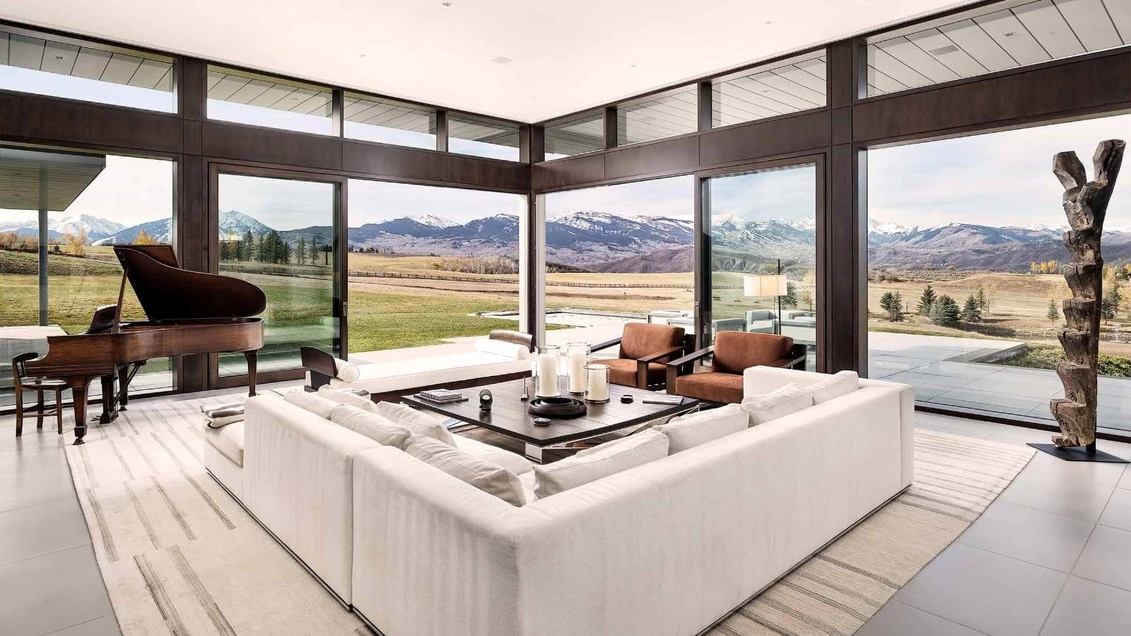 Living area with grand piano and panoramic mountain views