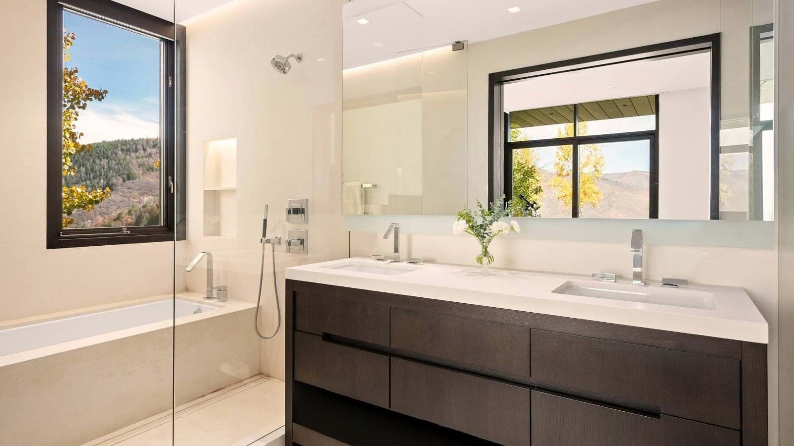 Bathroom with dual vanity, soaking tub, and walk-in wet room