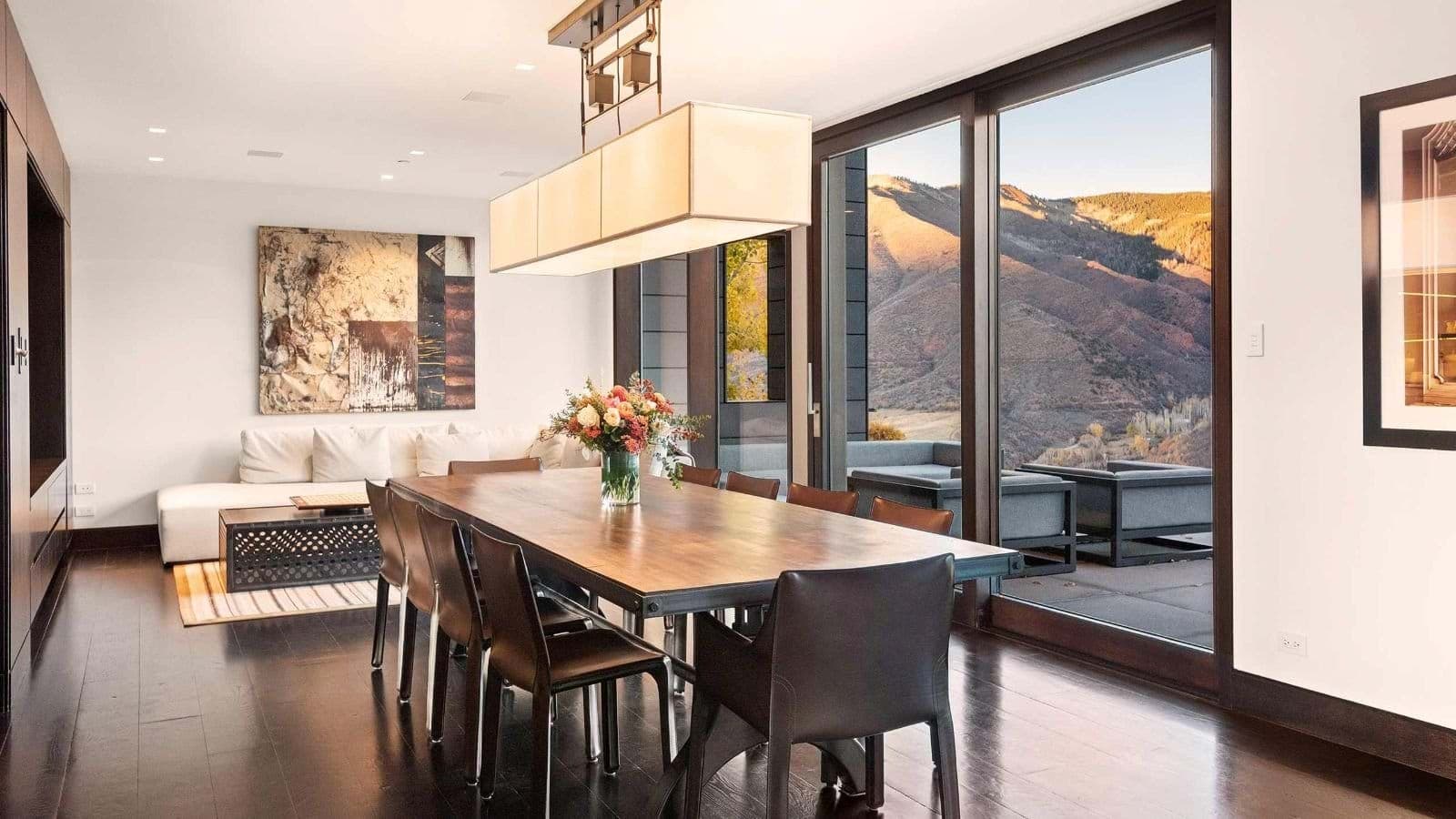 Dining area seats 10 with mountain views and patio access