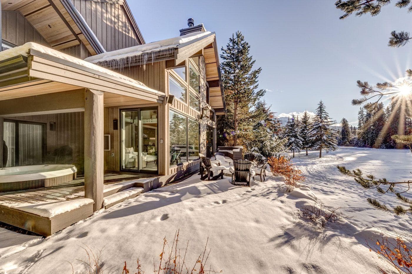 Covered patio with sunken hot tub and outdoor fire pit area