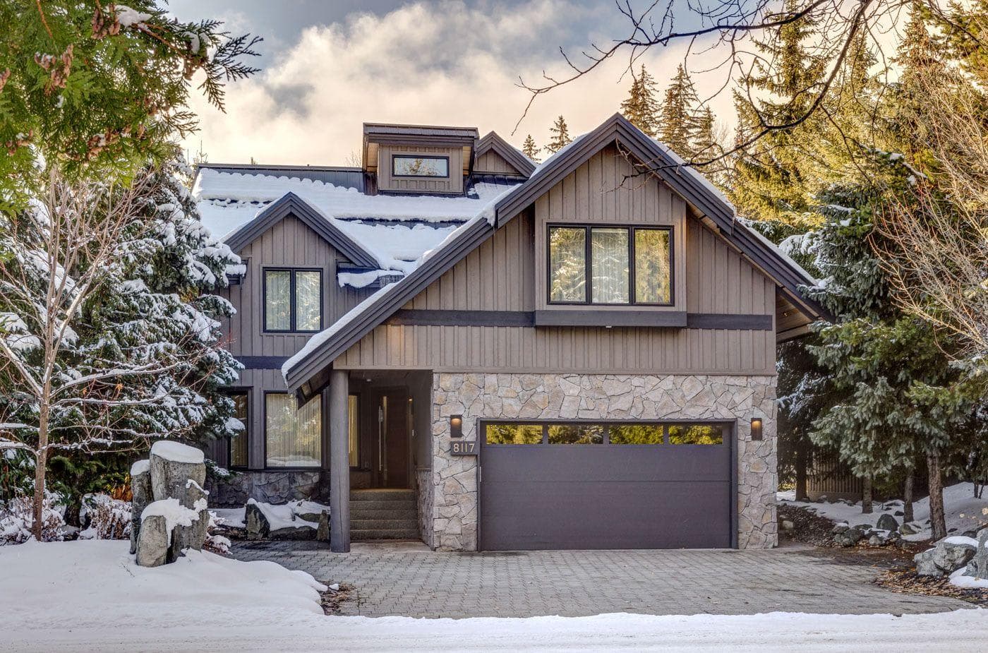Chalet exterior with heated paver driveway and two-car garage