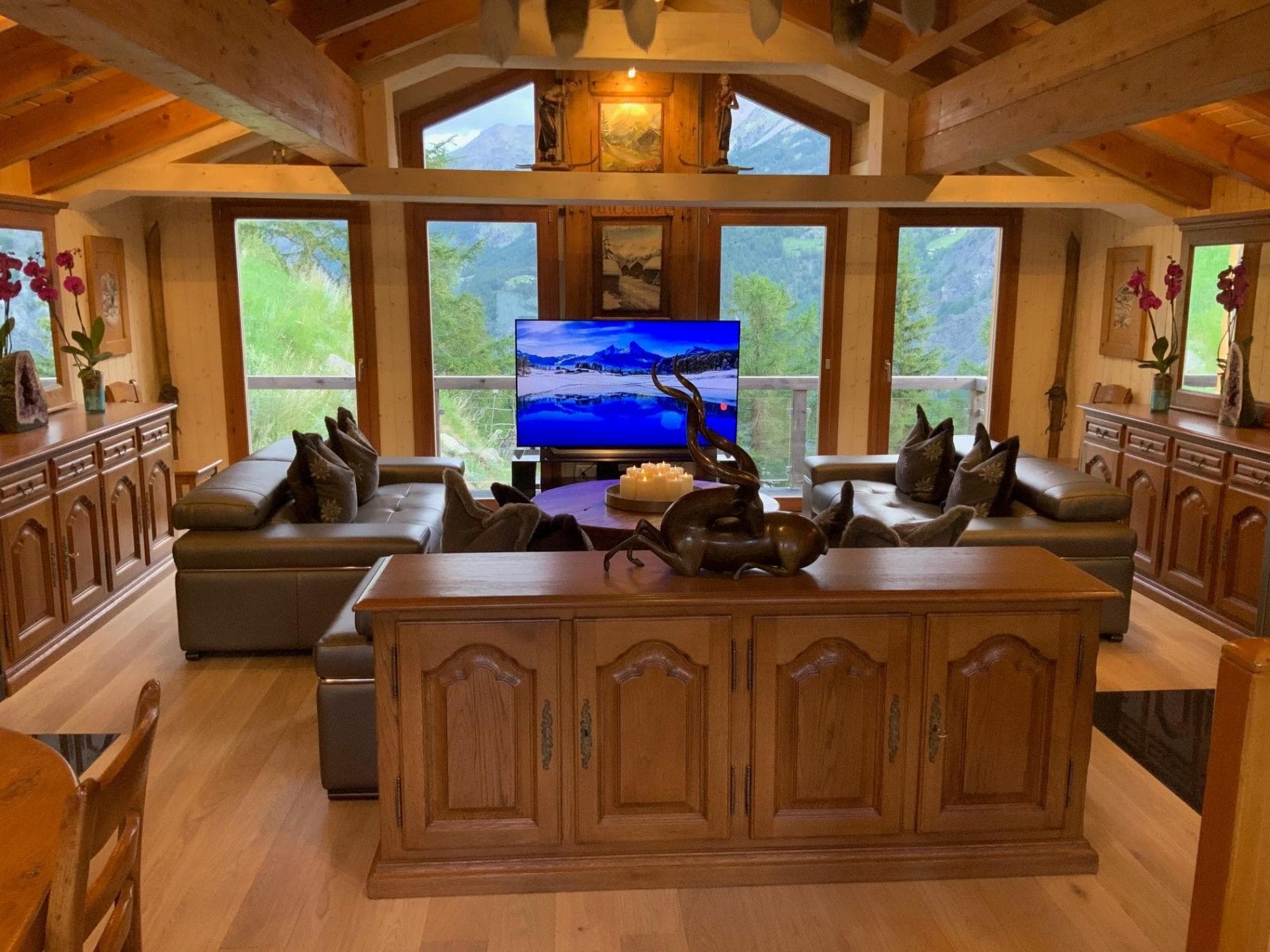 Living area with leather seating, exposed beams, and mountain valley views
