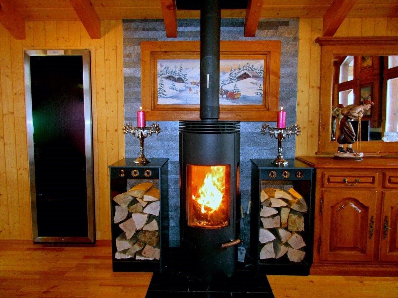 Wood-burning stove with stone hearth and integrated firewood storage