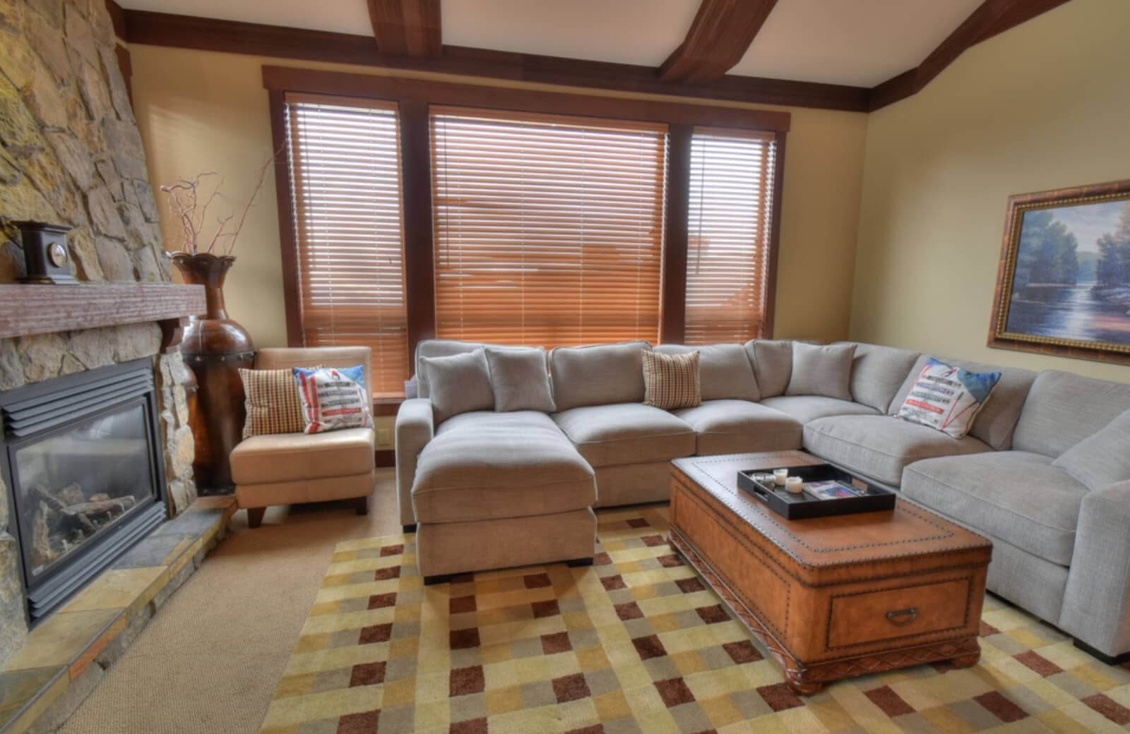 Living room with stone gas fireplace and sectional seating for 7