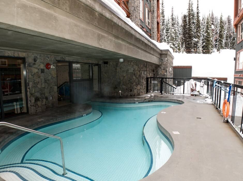 Shared outdoor heated pool with covered section and mountain views