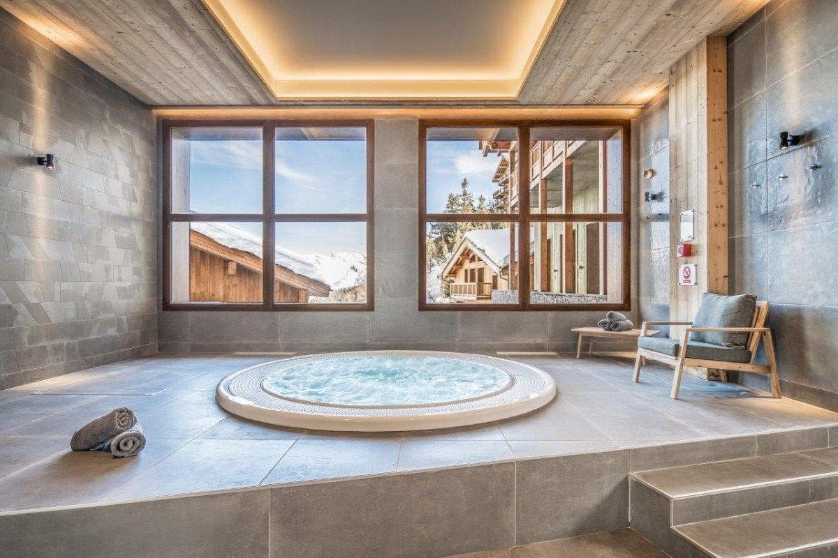 Indoor whirlpool with mountain views and dual wall-mounted showers