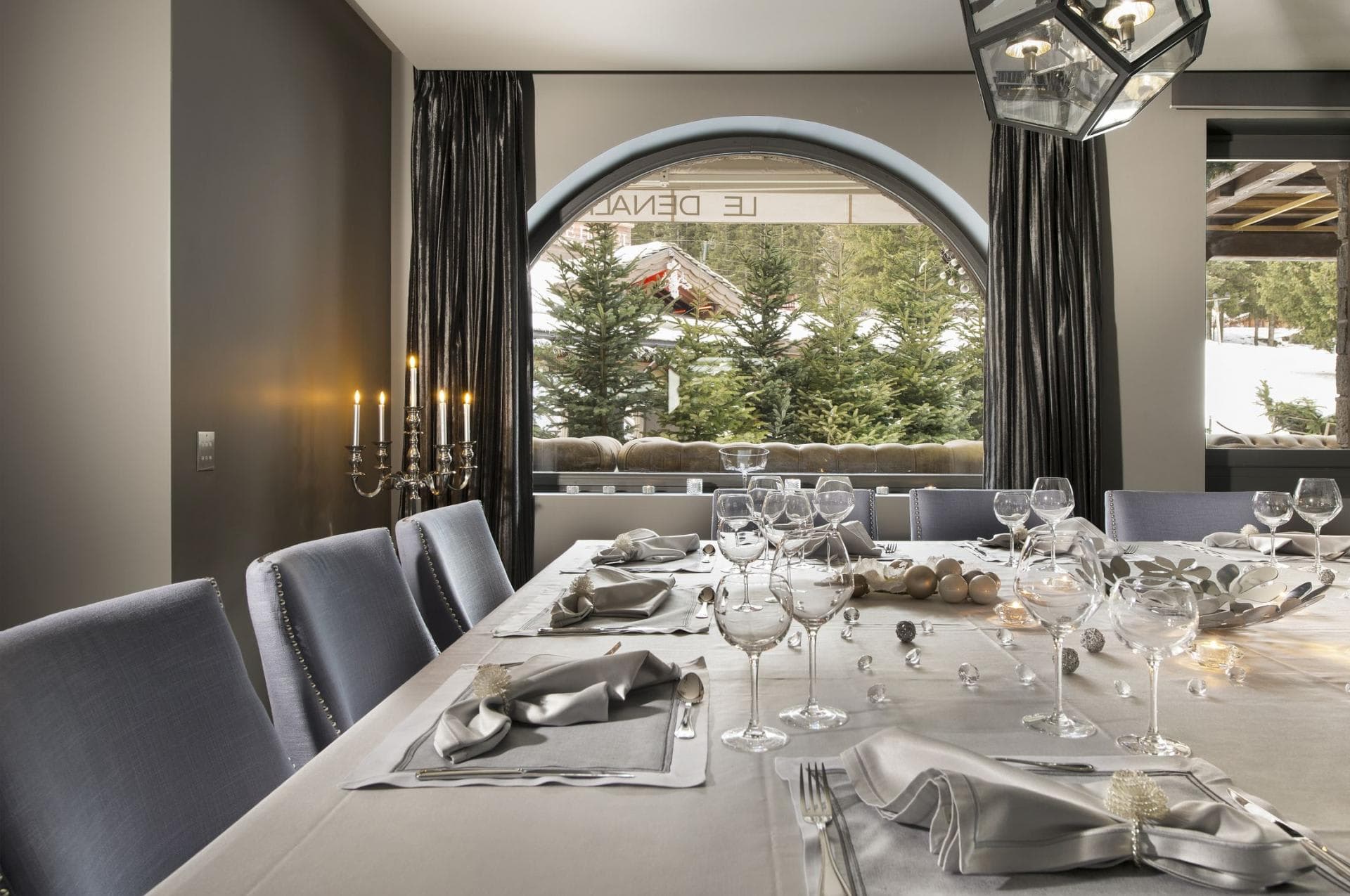 Dining area for 10 with arched window and mountain views