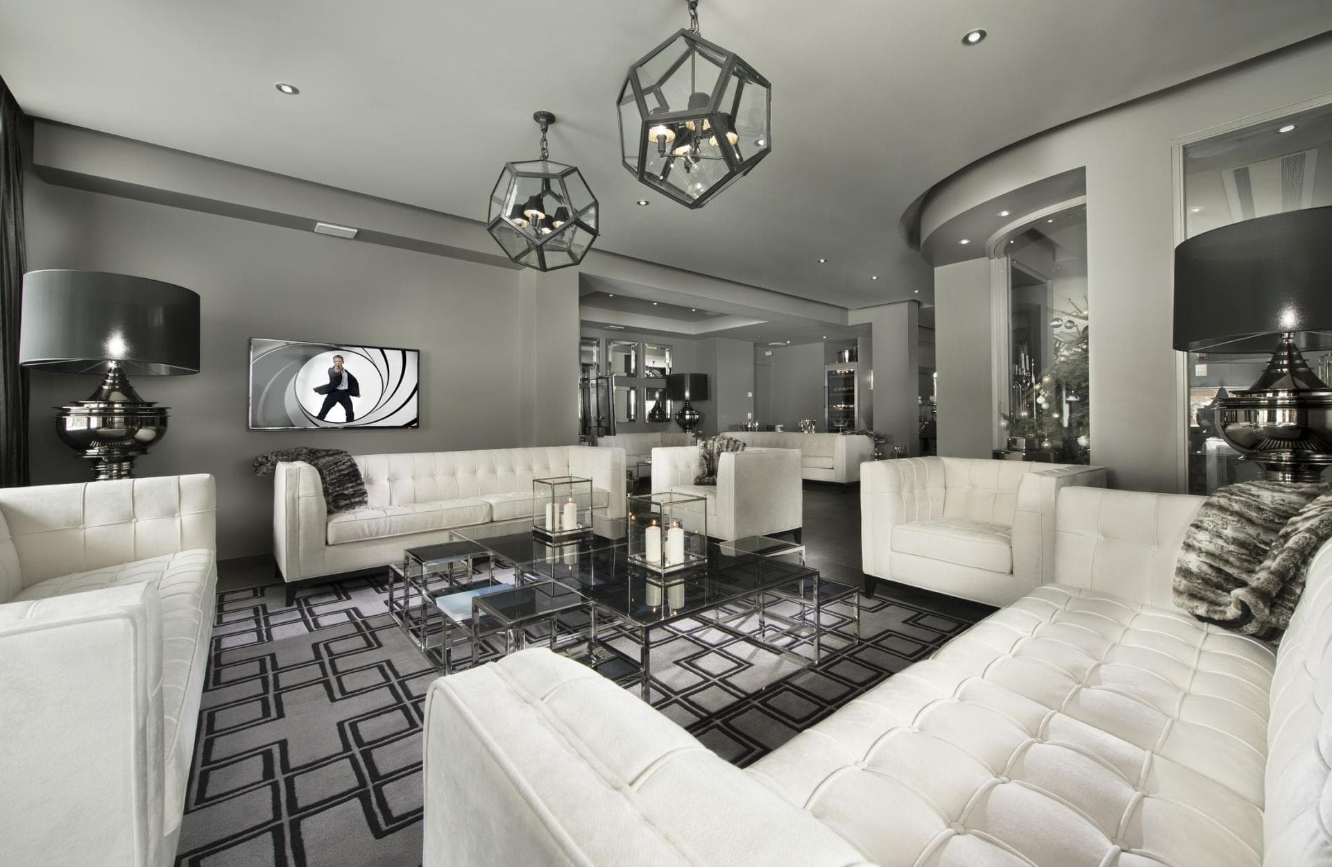 Living area with tufted velvet seating for 10 and wall-mounted TV