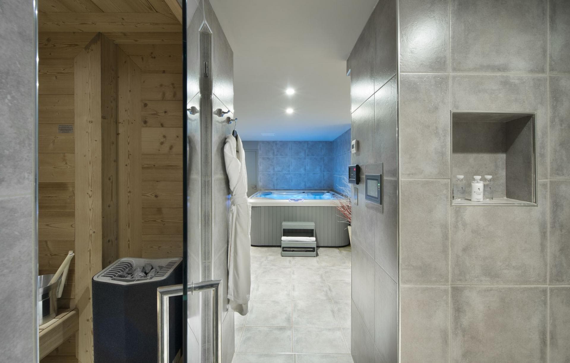 Private spa area featuring wood-paneled sauna and indoor hot tub