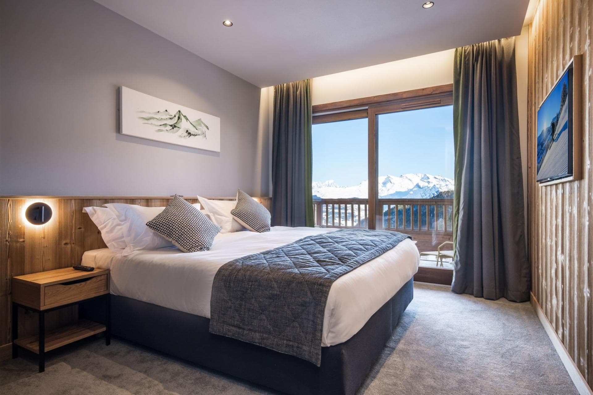Bedroom with king bed and balcony access; panoramic mountain views