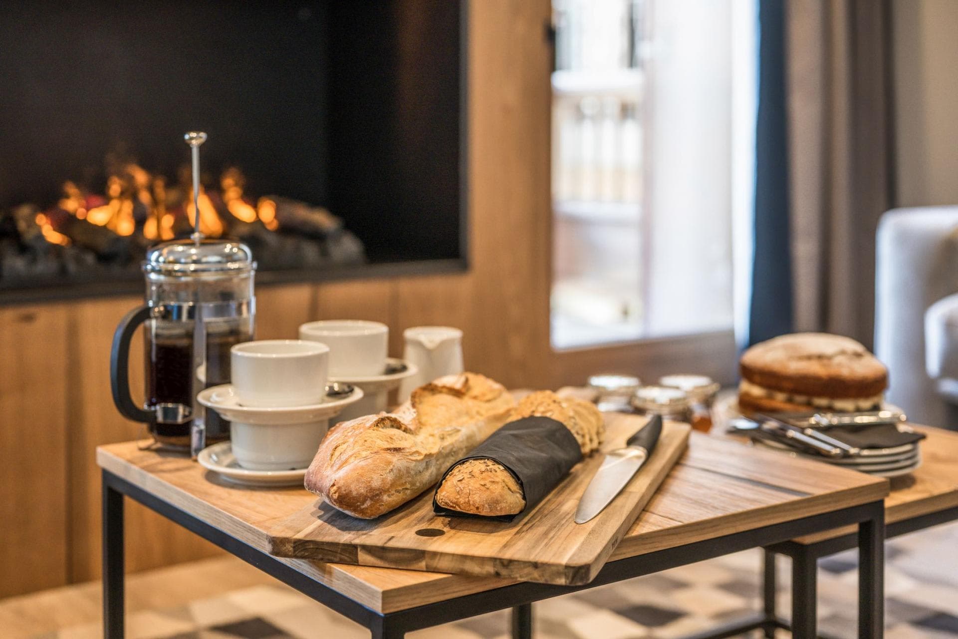 Living area with electric fireplace and coffee service setup