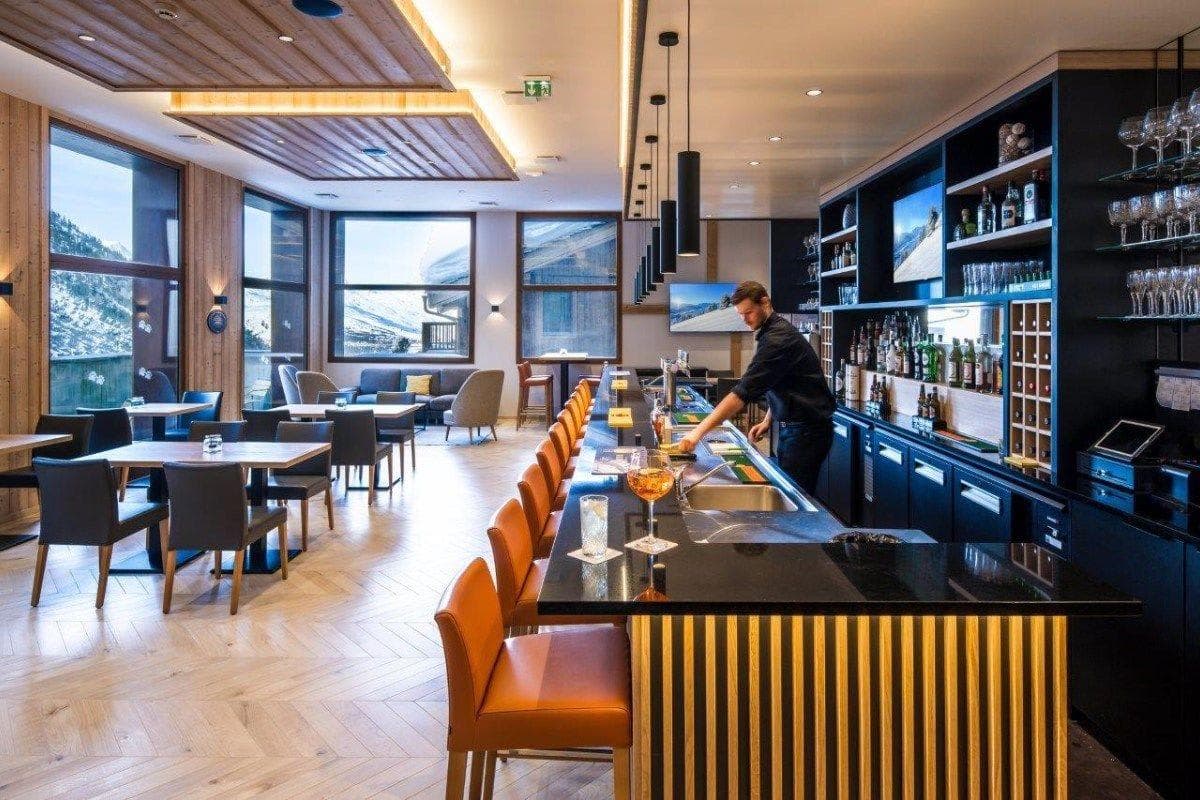 Full-service bar and lounge with mountain-view windows and seating for 20+