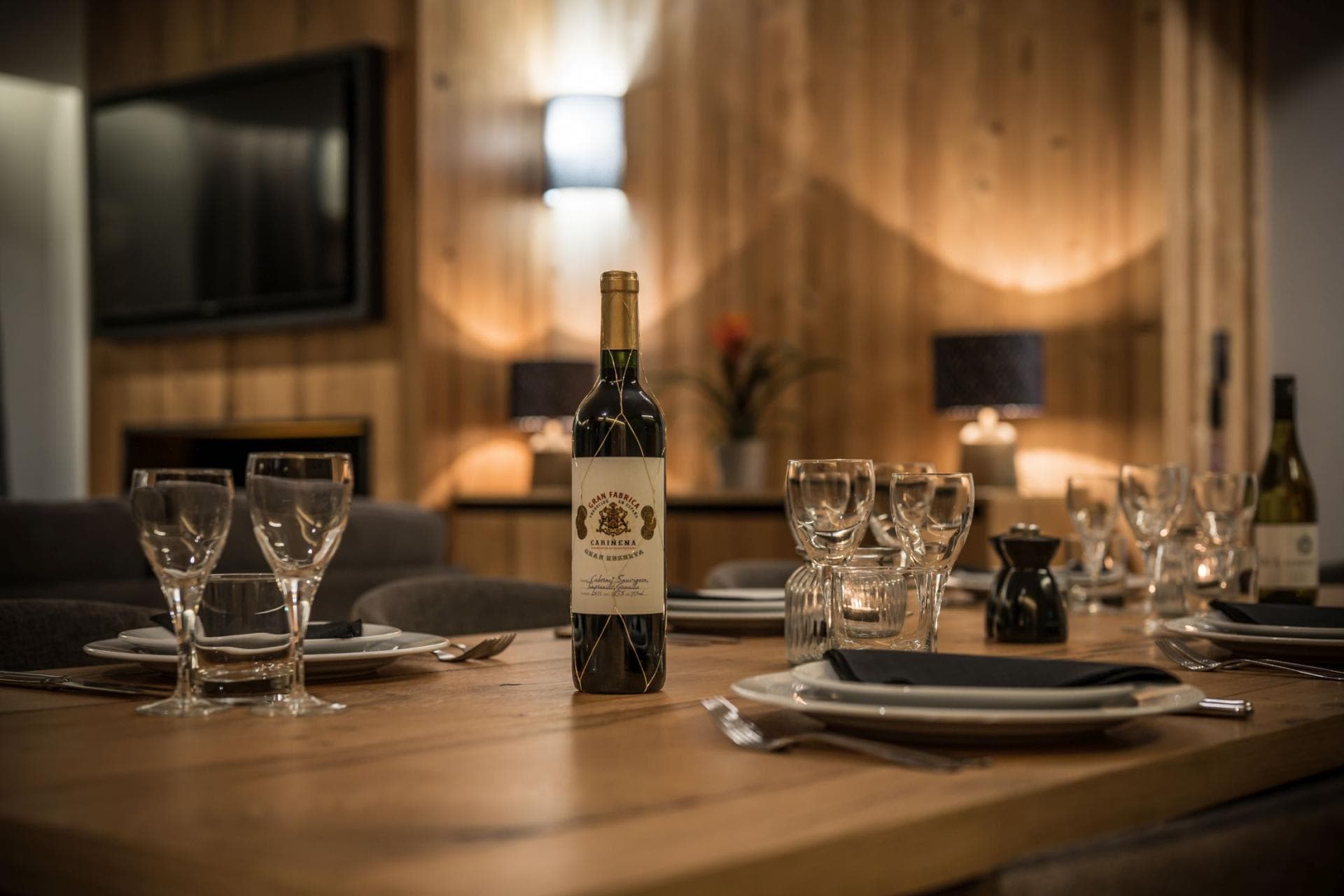 Dining area with wood table and view of living room fireplace