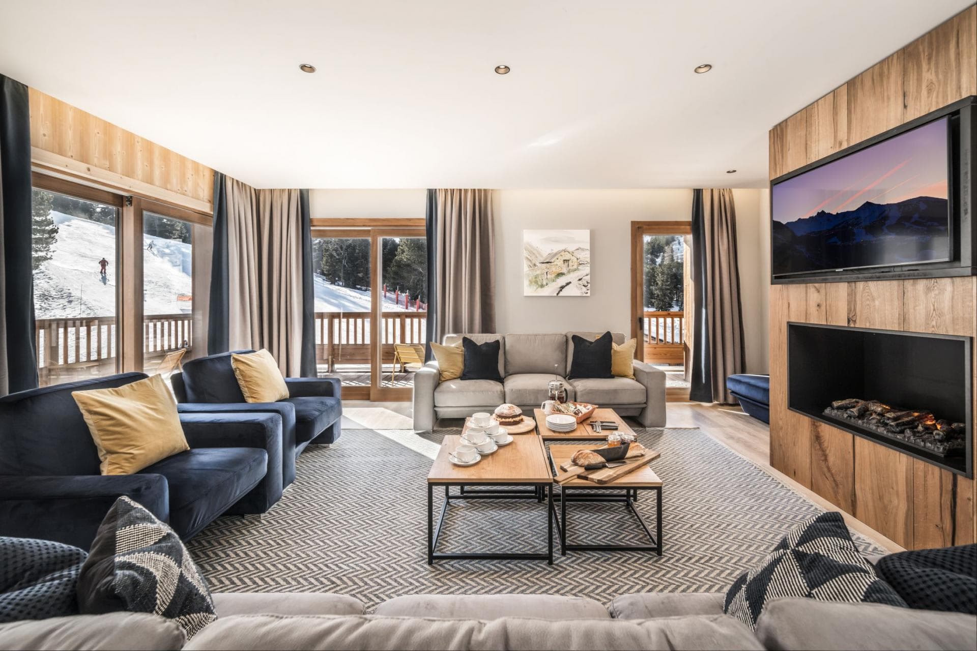 Living area with electric fireplace and ski-in/ski-out balcony access