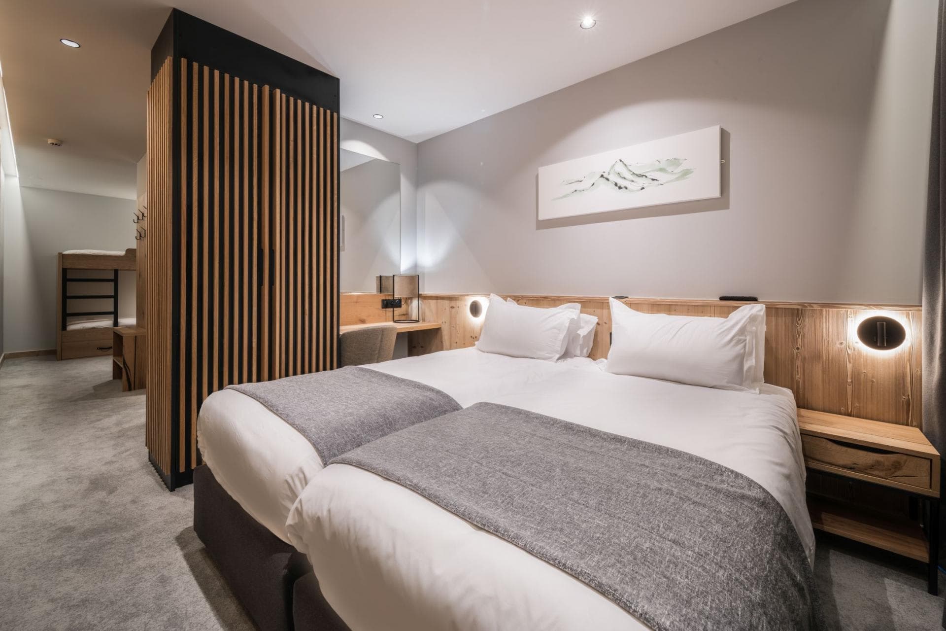 Family bedroom with two twin beds and adjacent bunk bed nook