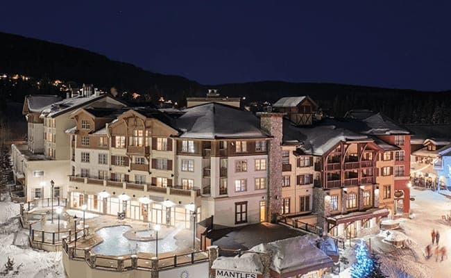 Mountain resort exterior with heated outdoor pool and hot tub
