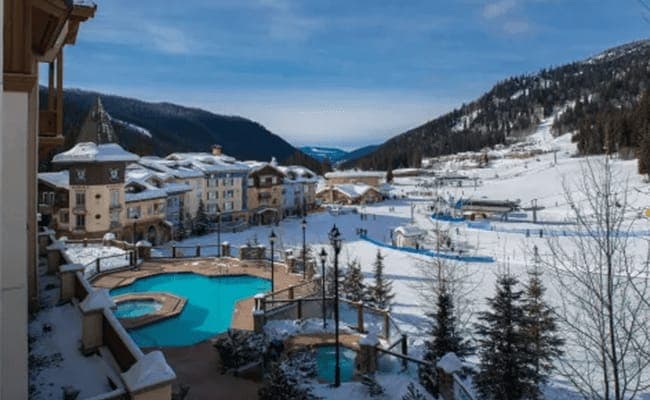 Heated outdoor pool and hot tubs with views of ski lifts