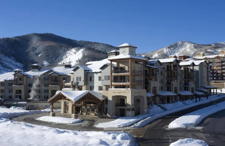 Mountain lodge with clock tower and ski slope views