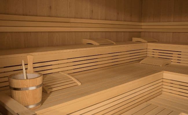 Private sauna with multi-level seating and ergonomic wooden headrests