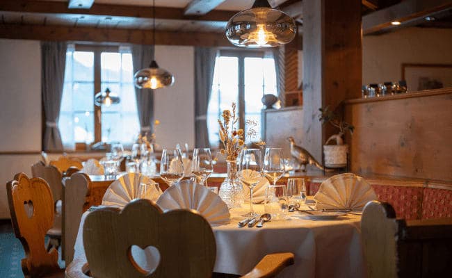 Dining area with traditional carved heart seating and mountain views