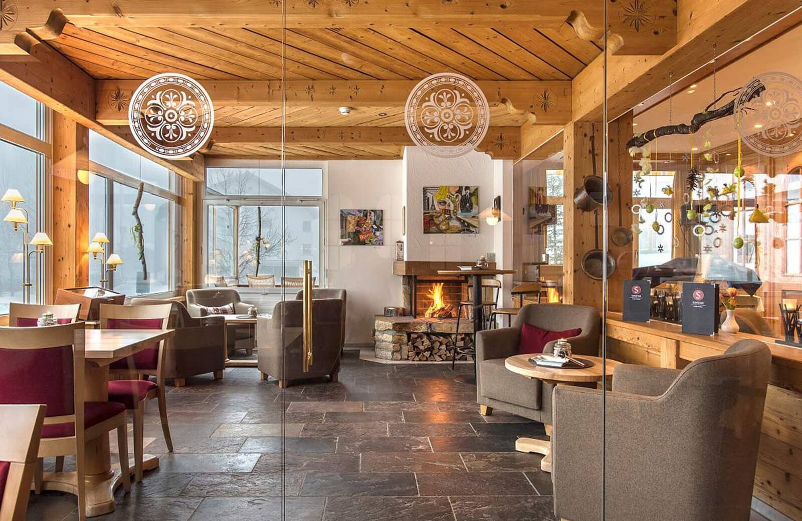 Lounge area with wood-burning fireplace and slate tile flooring