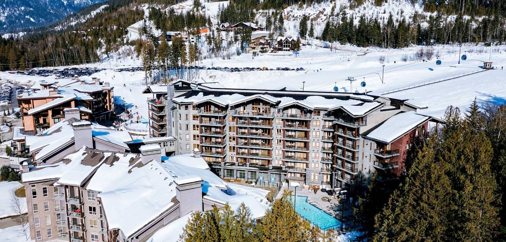 Ski-in/ski-out resort exterior with heated pool and gondola access