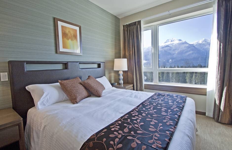 Guest bedroom with king bed and mountain peak views
