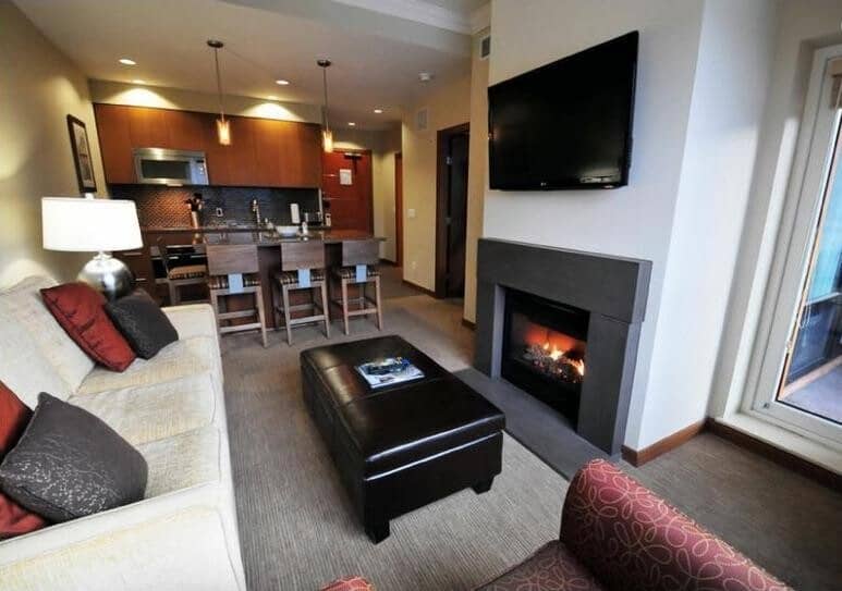 Open living area with gas fireplace and breakfast bar seating for 3