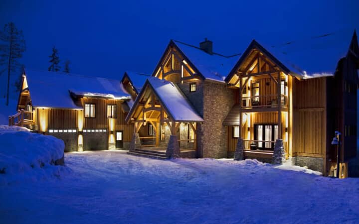 Ski-in chalet exterior with two-car garage and timber-frame entry