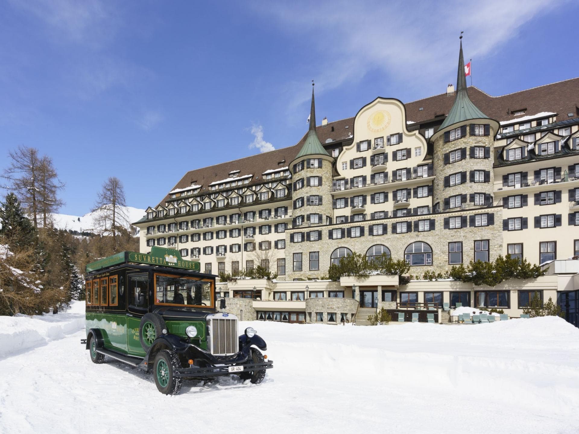 Hotel exterior with vintage shuttle bus and ski-in/ski-out access