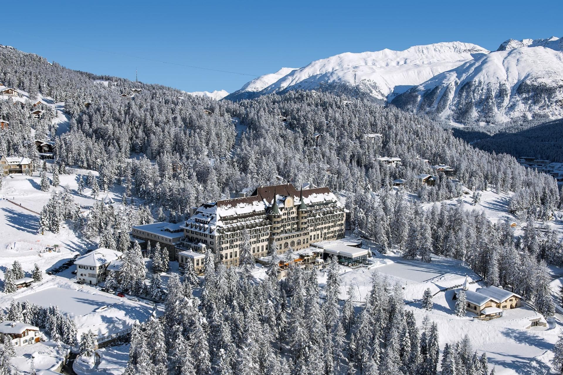 Aerial view of mountain resort with ski-in/ski-out access and forest surroundings