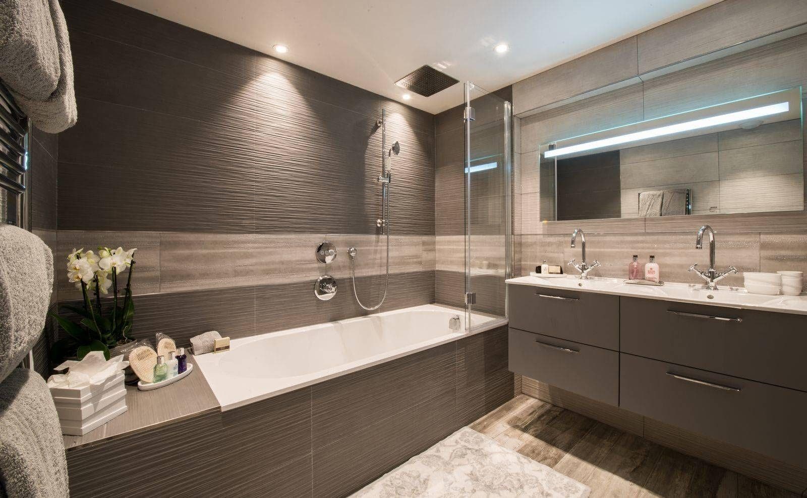 Bathroom with dual vanity, soaking tub, and rainfall shower head