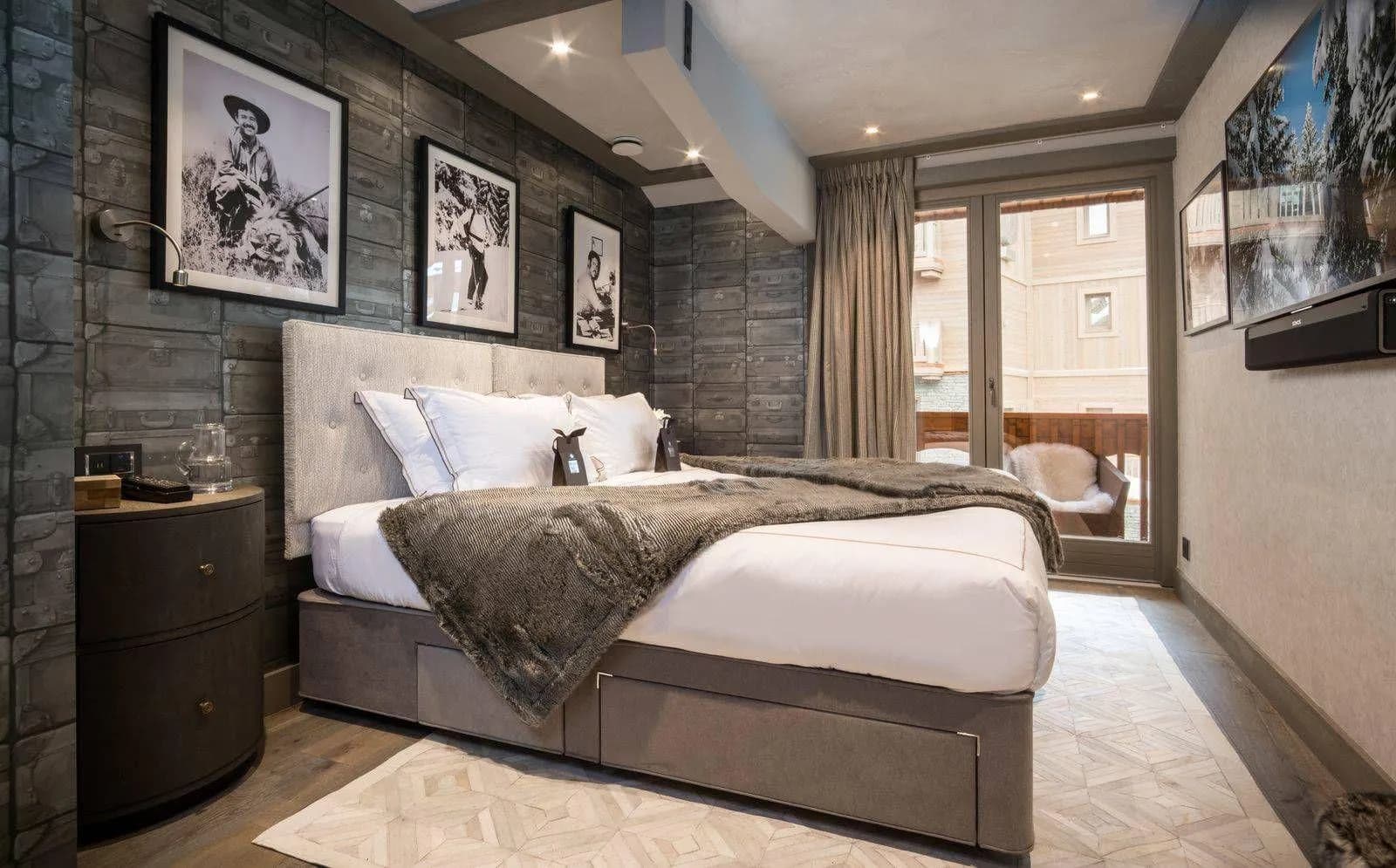 Double bedroom with balcony access and a timber-framed bed