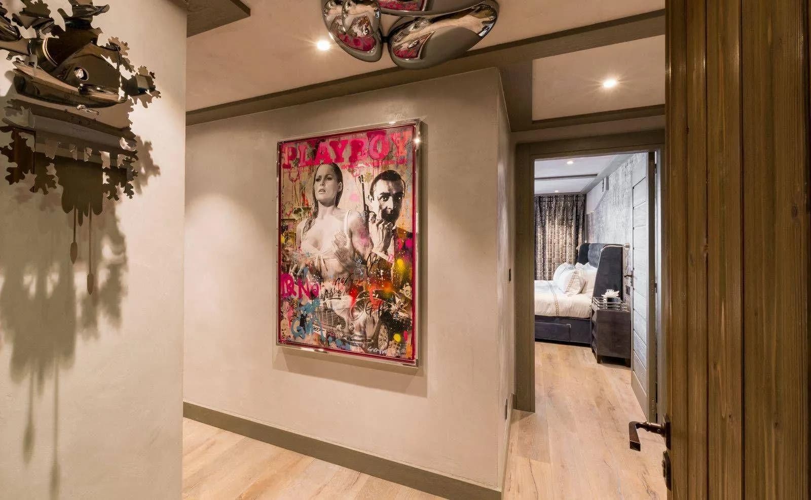 Hallway with framed artwork and a cuckoo clock