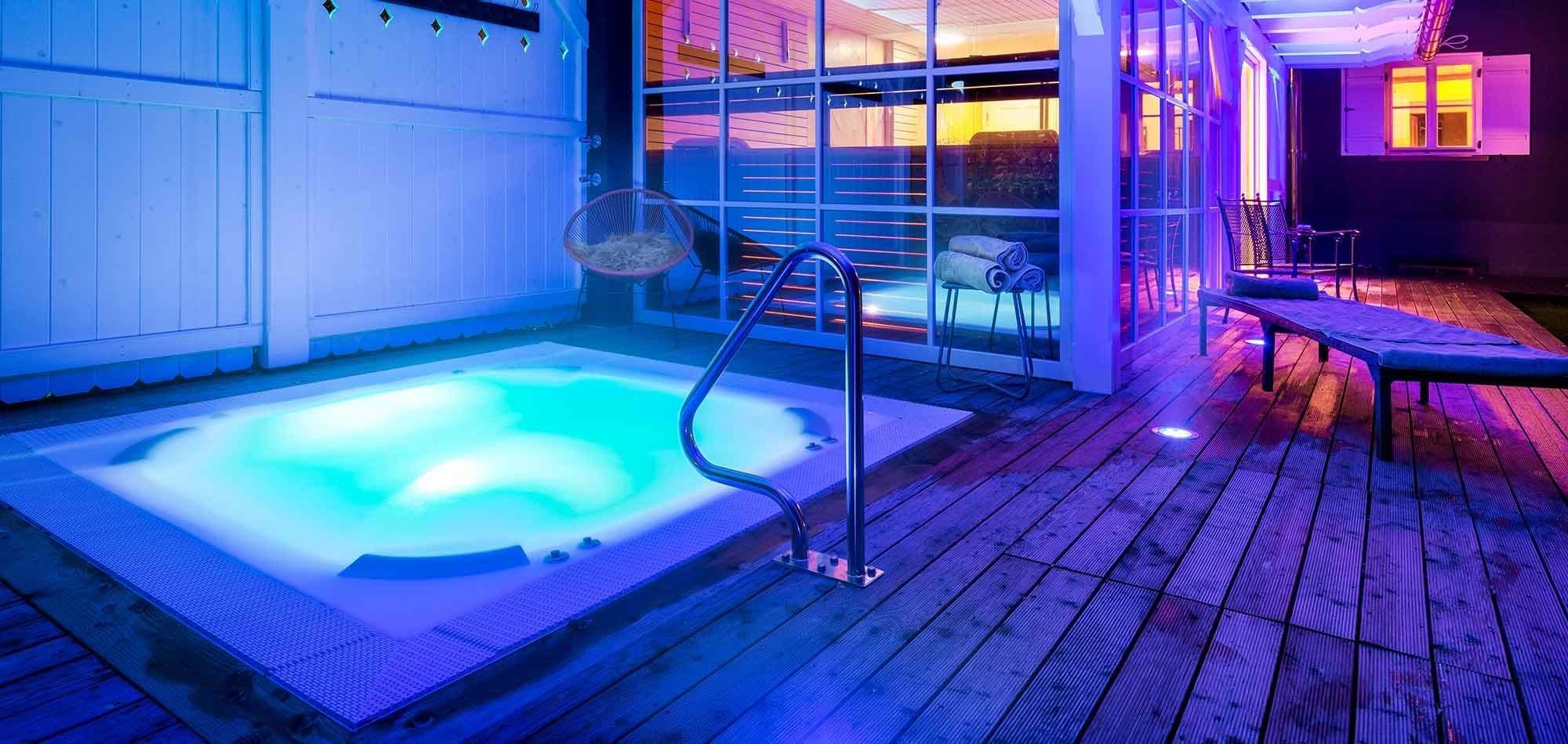 In-deck hot tub with handrail and adjacent sun loungers