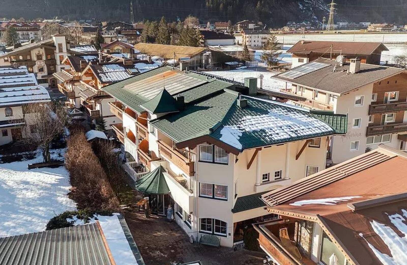 Aerial view of chalet exterior with private balconies and village surroundings