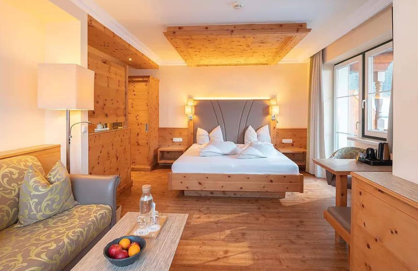 Guest suite with king bed, pine paneling, and integrated sitting area