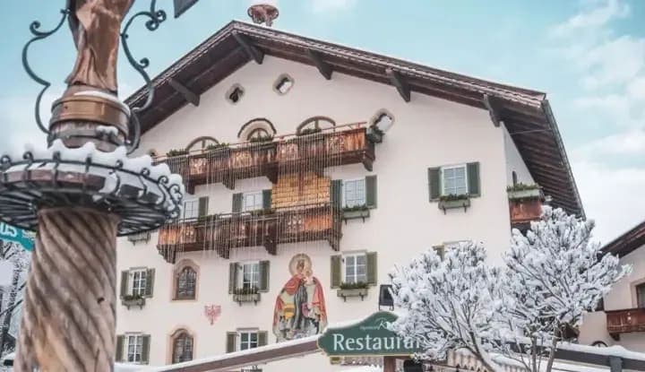 Chalet exterior with traditional murals and proximity to local restaurants