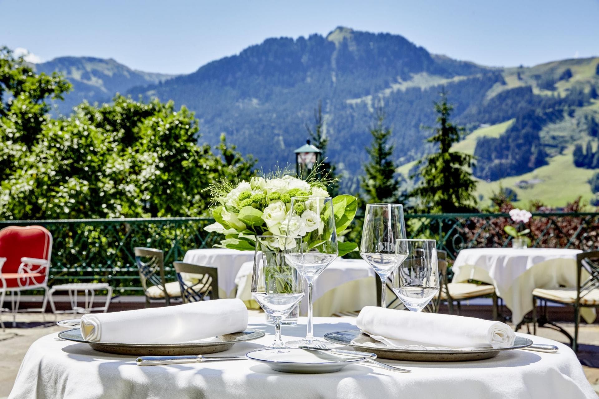Terrace dining area with mountain views and white linens