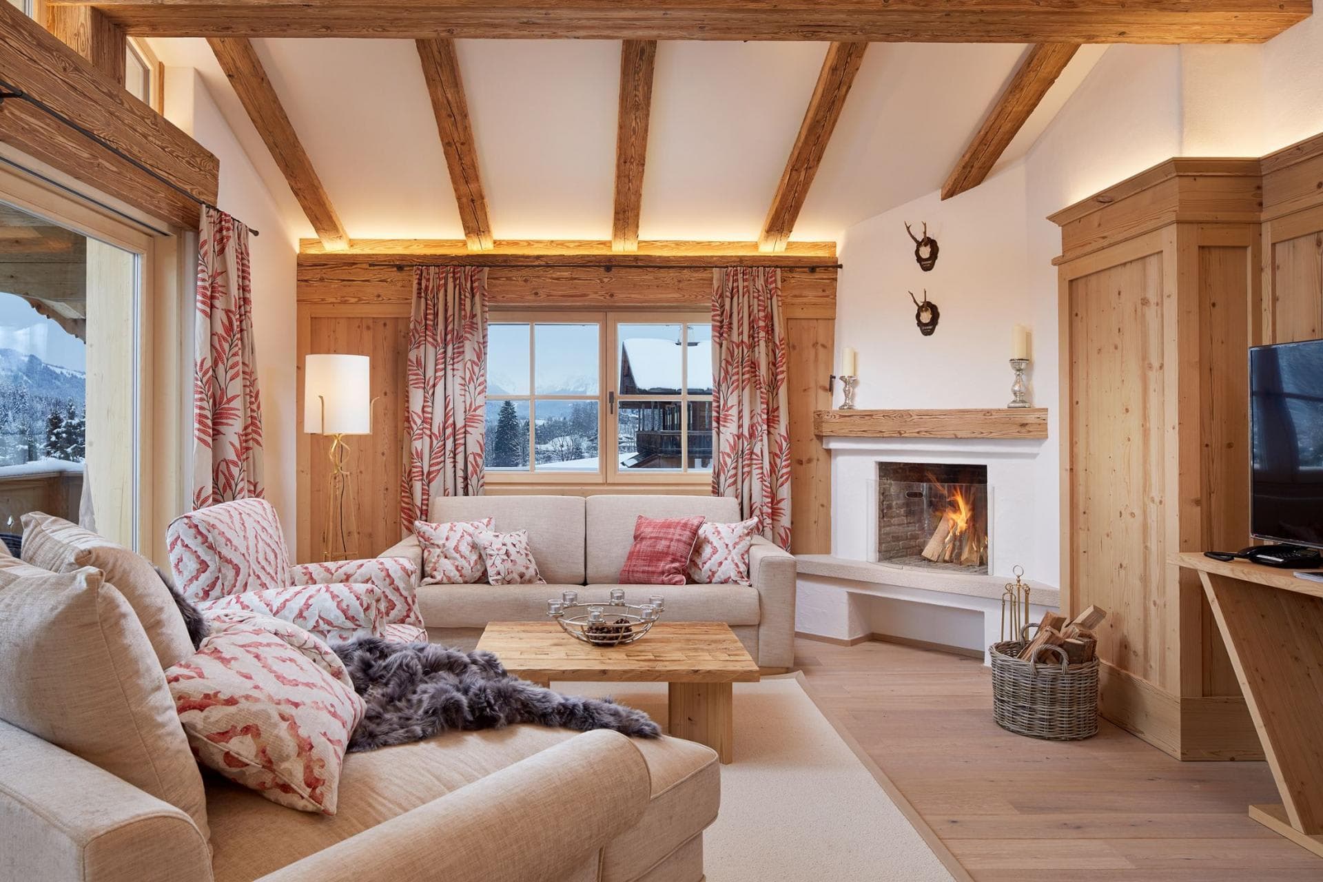 Living room with wood-burning fireplace and mountain-view windows