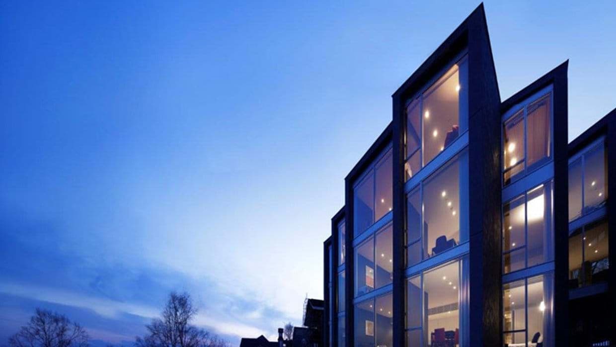 Exterior facade with floor-to-ceiling windows and charcoal wood siding