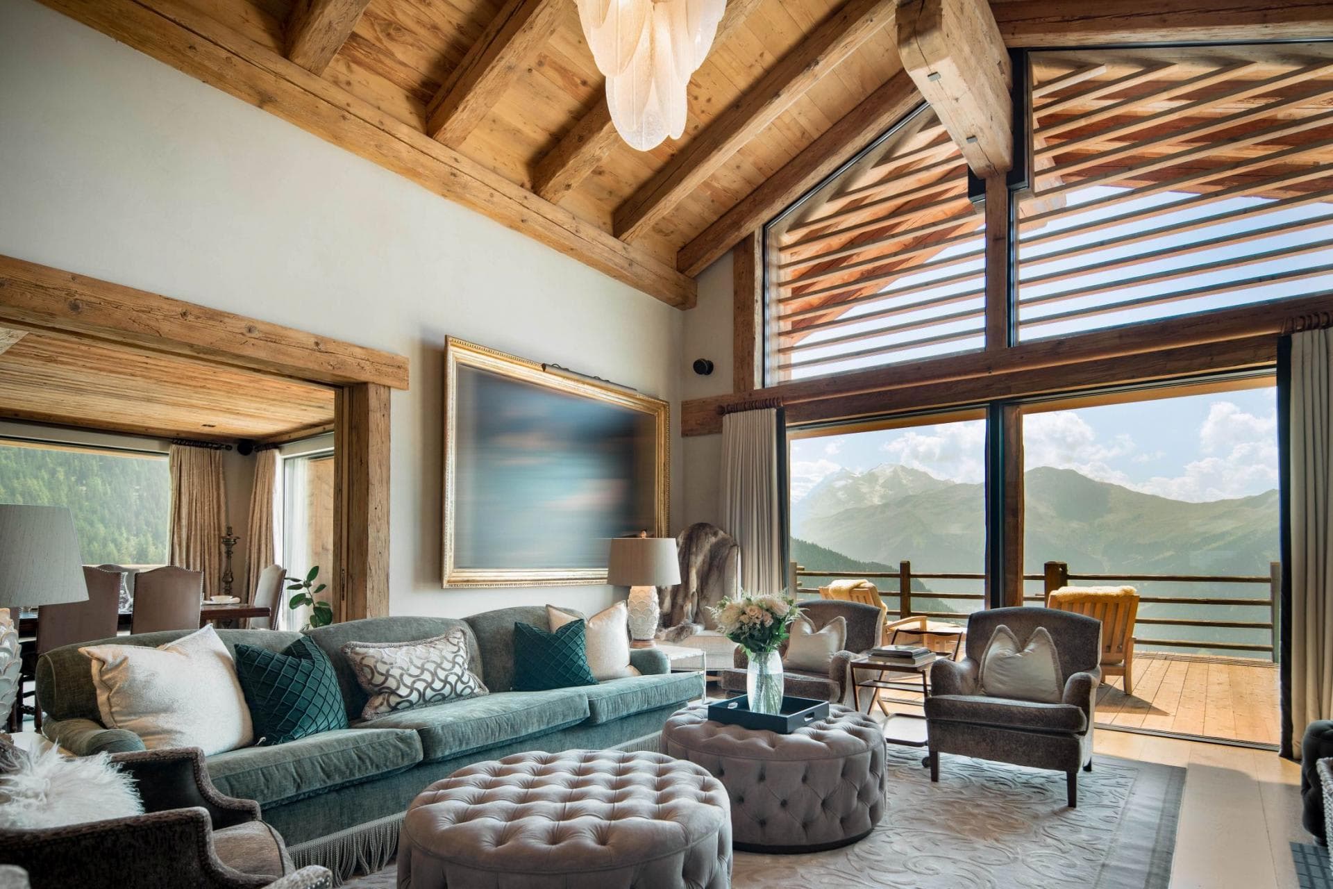Living area with vaulted wood ceiling and floor-to-ceiling mountain views