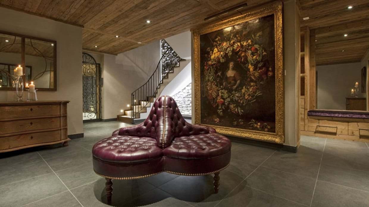 Lower level entry hall with leather tufted seating and private elevator