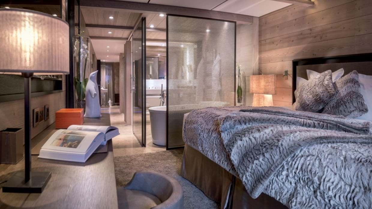 Primary suite with king bed and glass-enclosed ensuite soaking tub