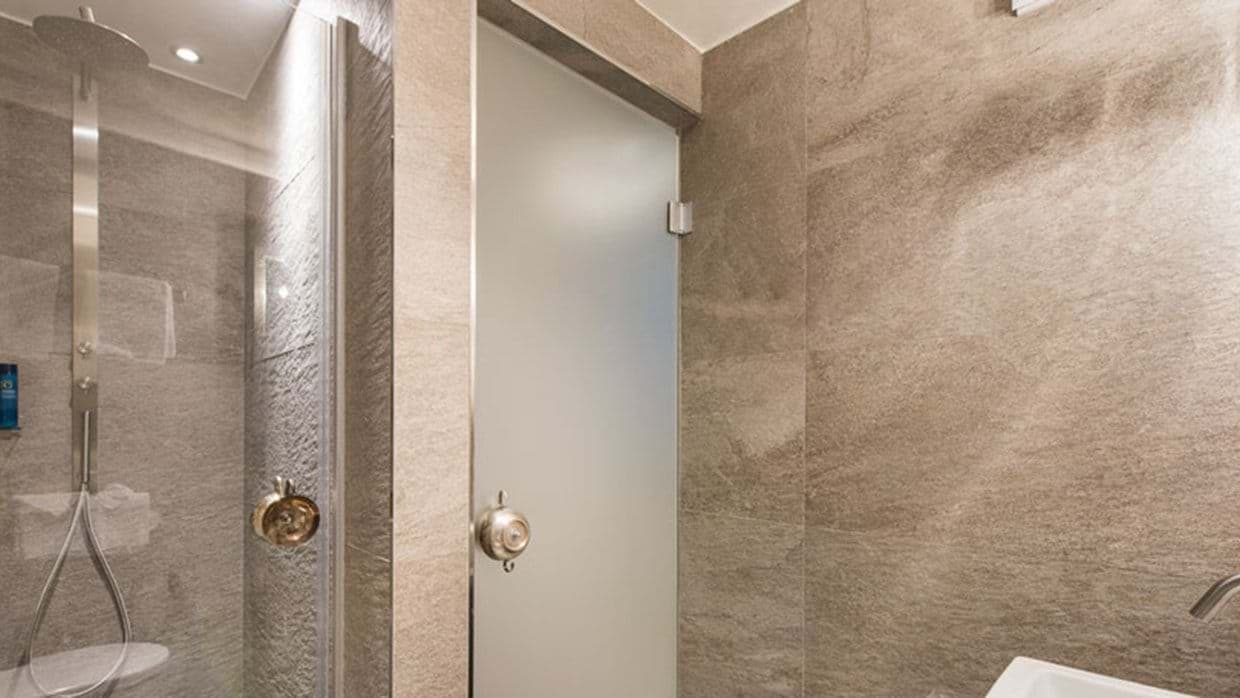Bathroom with walk-in rainfall shower and handheld wand