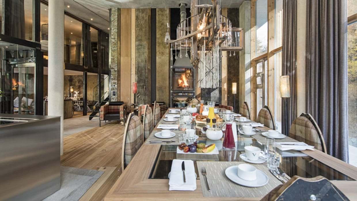 Dining area seating 10 with glass-top table and wood-burning fireplace