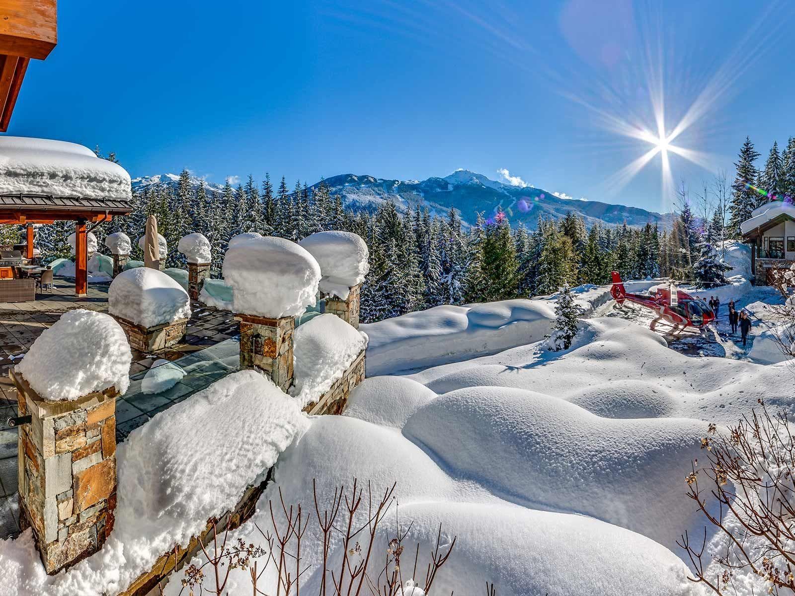 Stone patio with mountain views and private helicopter landing area